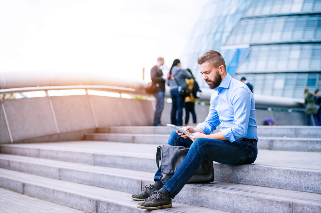 Manager With Tablet Sitting On Stairs London City PGB92TN 1024x681